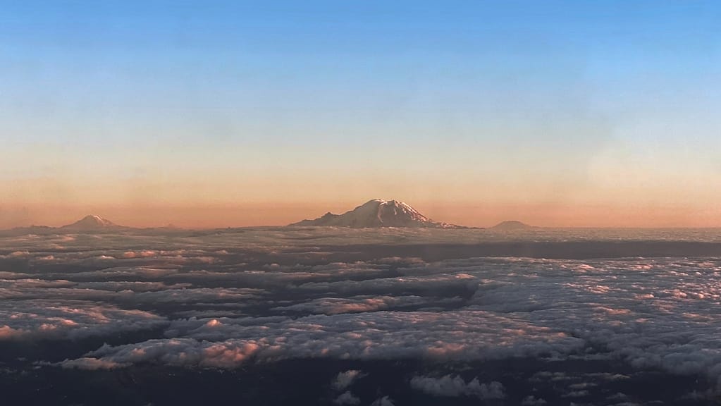 Adams, Rainier and Saint Helens of the Cascades from the air on arrival into Seattle