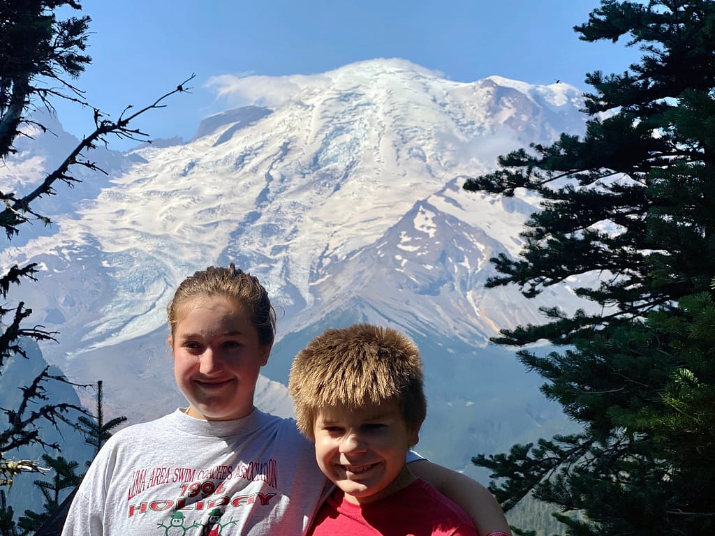 Kids posing at Mount Rainier overlook at Sunrise