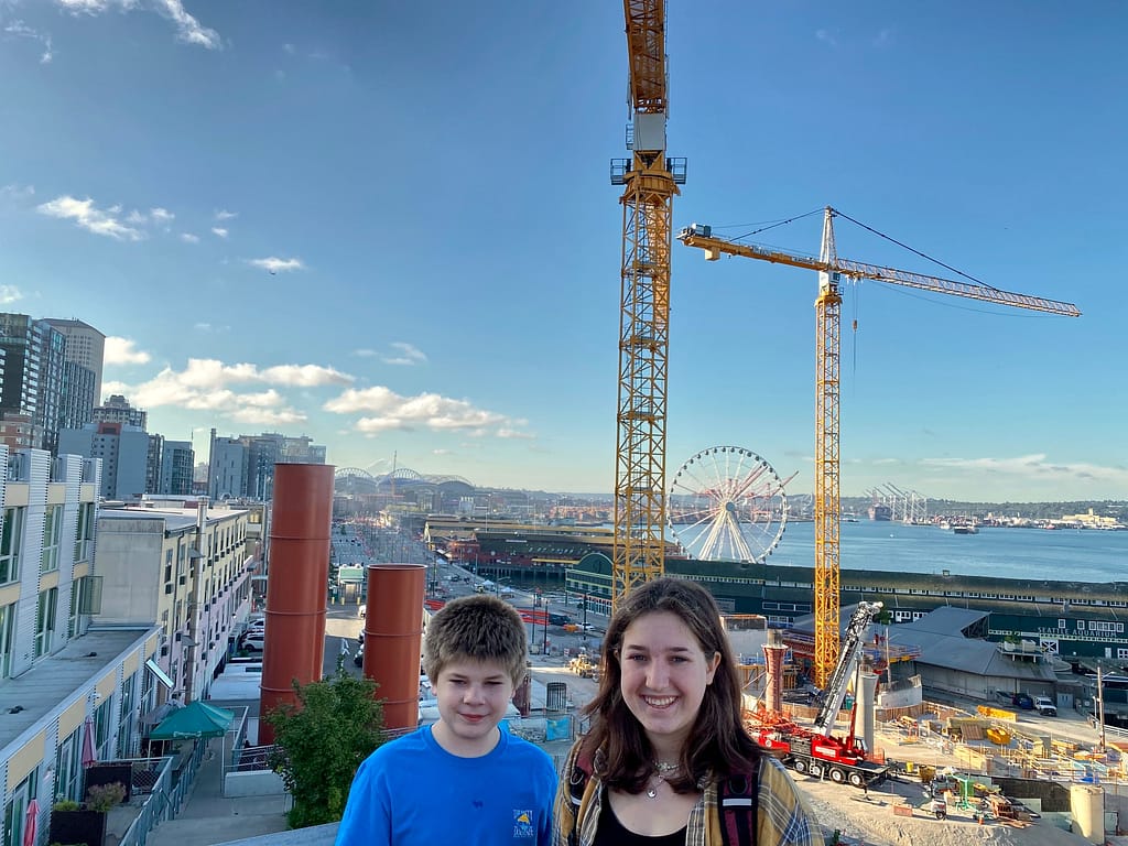 Kids posing in Seattle with the waterfront and Mount Rainier in the backdrop
