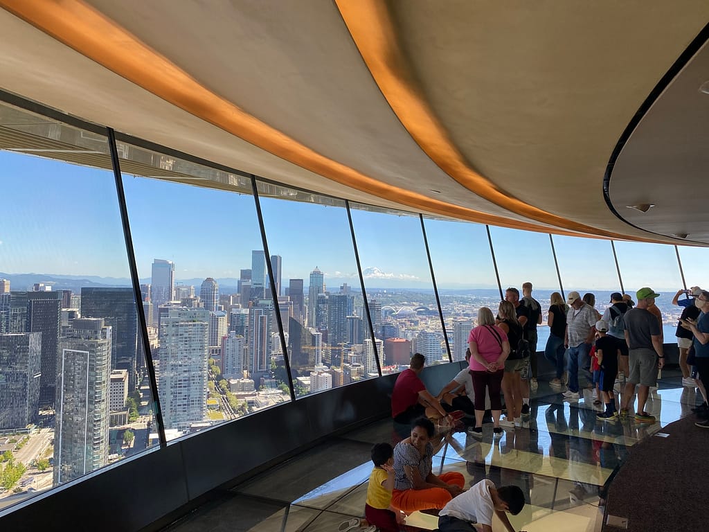 View from Space Needle of Seattle with Mt. Rainier in distance and rotating glass floor on lower level