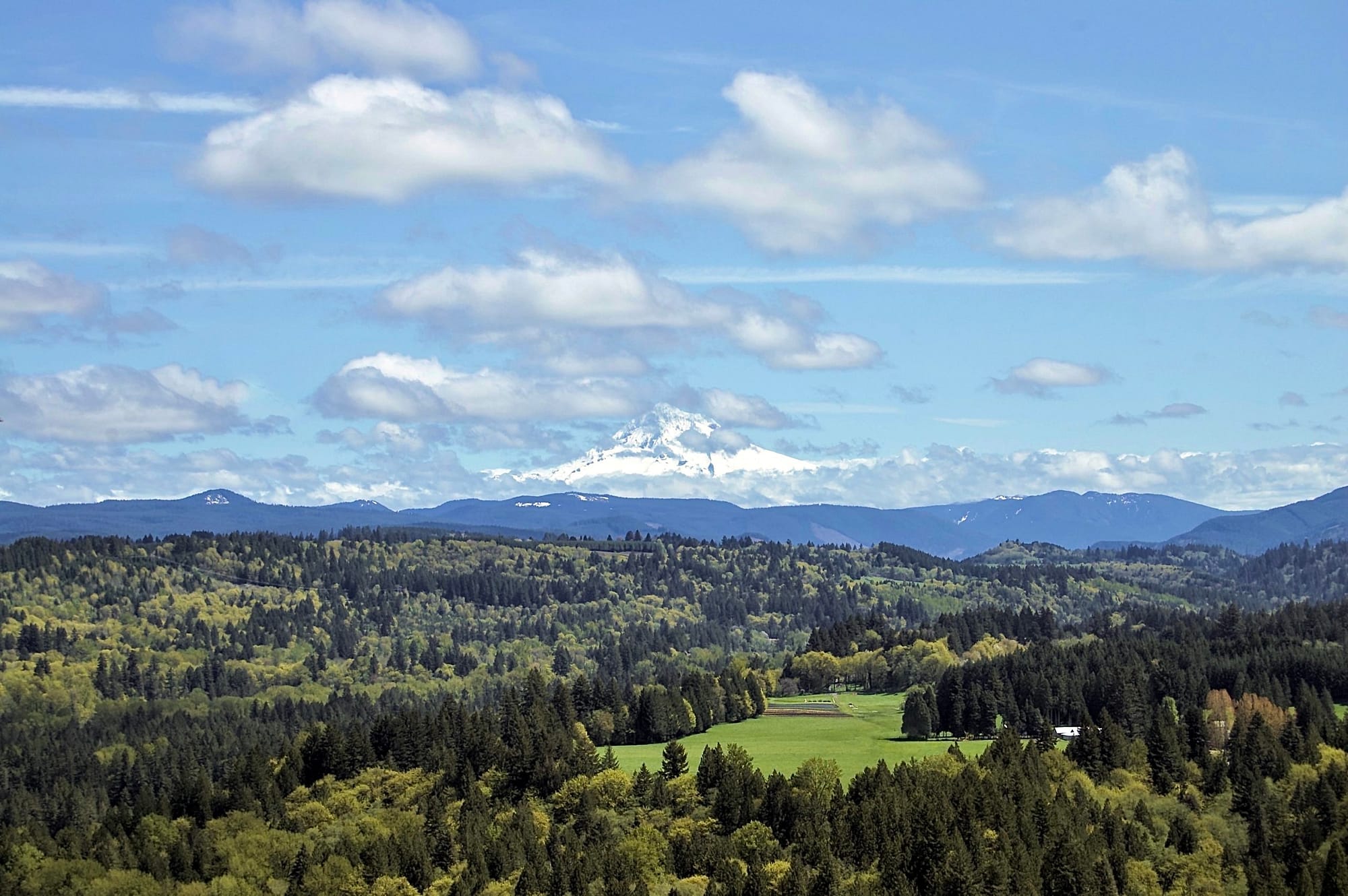A small break in the clouds for Mt. Hood to appear as seen from Sandy, Oregon