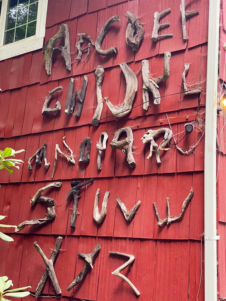 Found tree branches in the shapes of letters of the alphabet adorn the side side of Copper Creek Inn